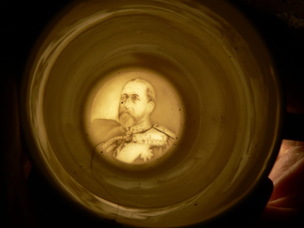 Photograph of translucent image of Edward VII in base of teacup